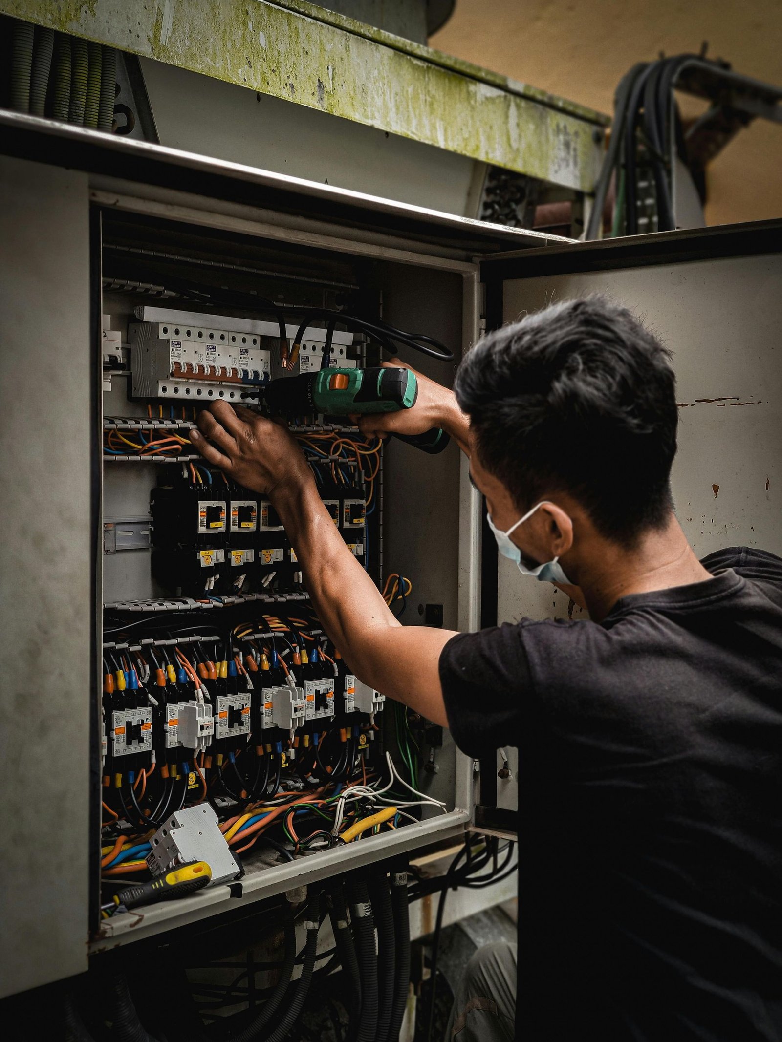 Man working on electrical panel-Prestige Facility Solutions
